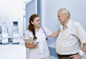 Dialysis nurse with patient in front of the treatment room