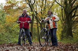 Couple cycling in a forest